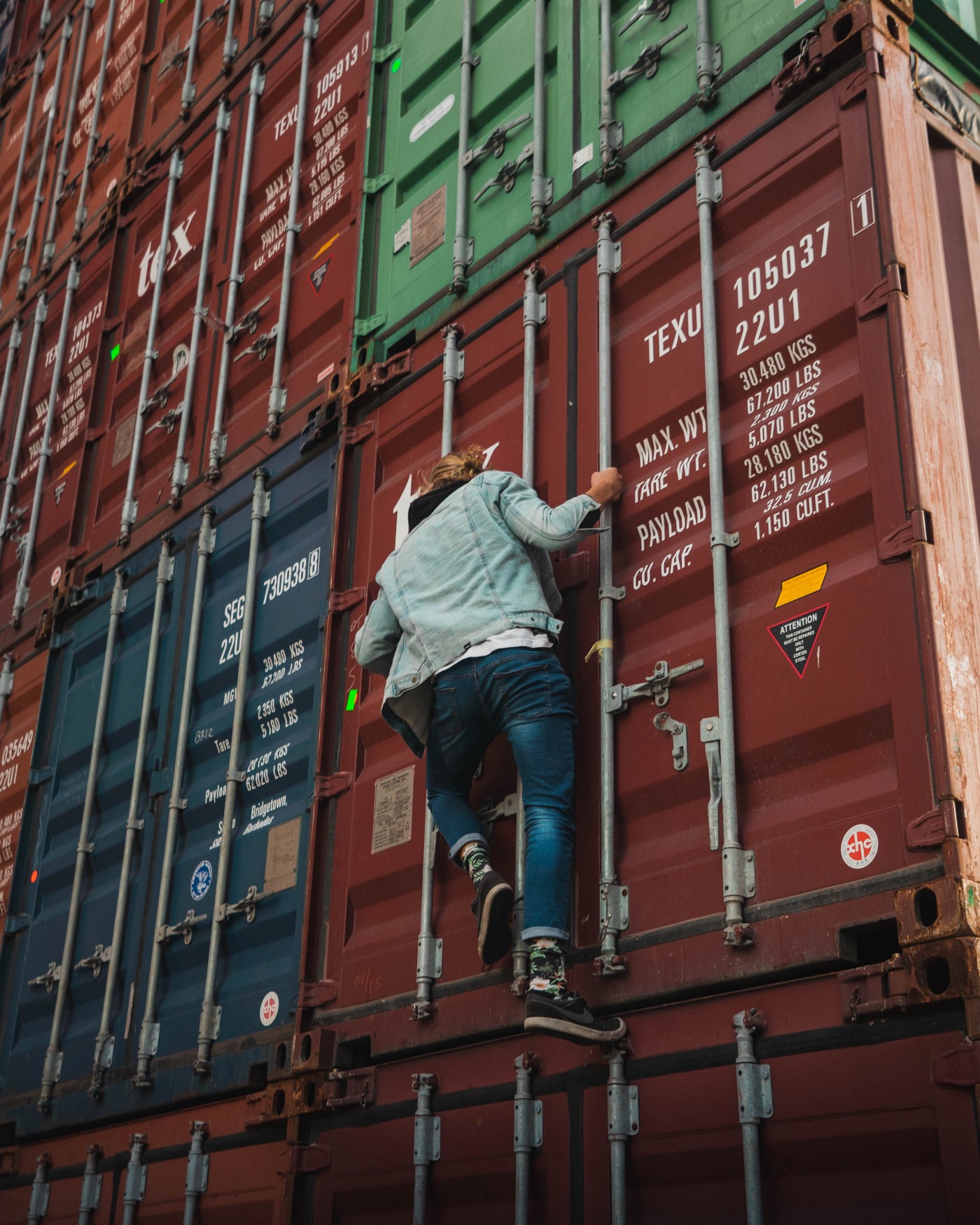 person climbing containers